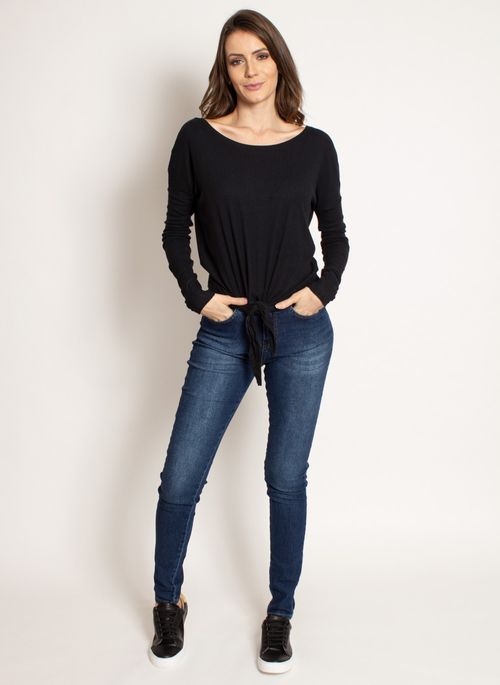 Calça jeans feminina skinny com blusa preta com nó e sapatênis neutro é look básico com calça jeans feminino versátil, prático e estiloso
